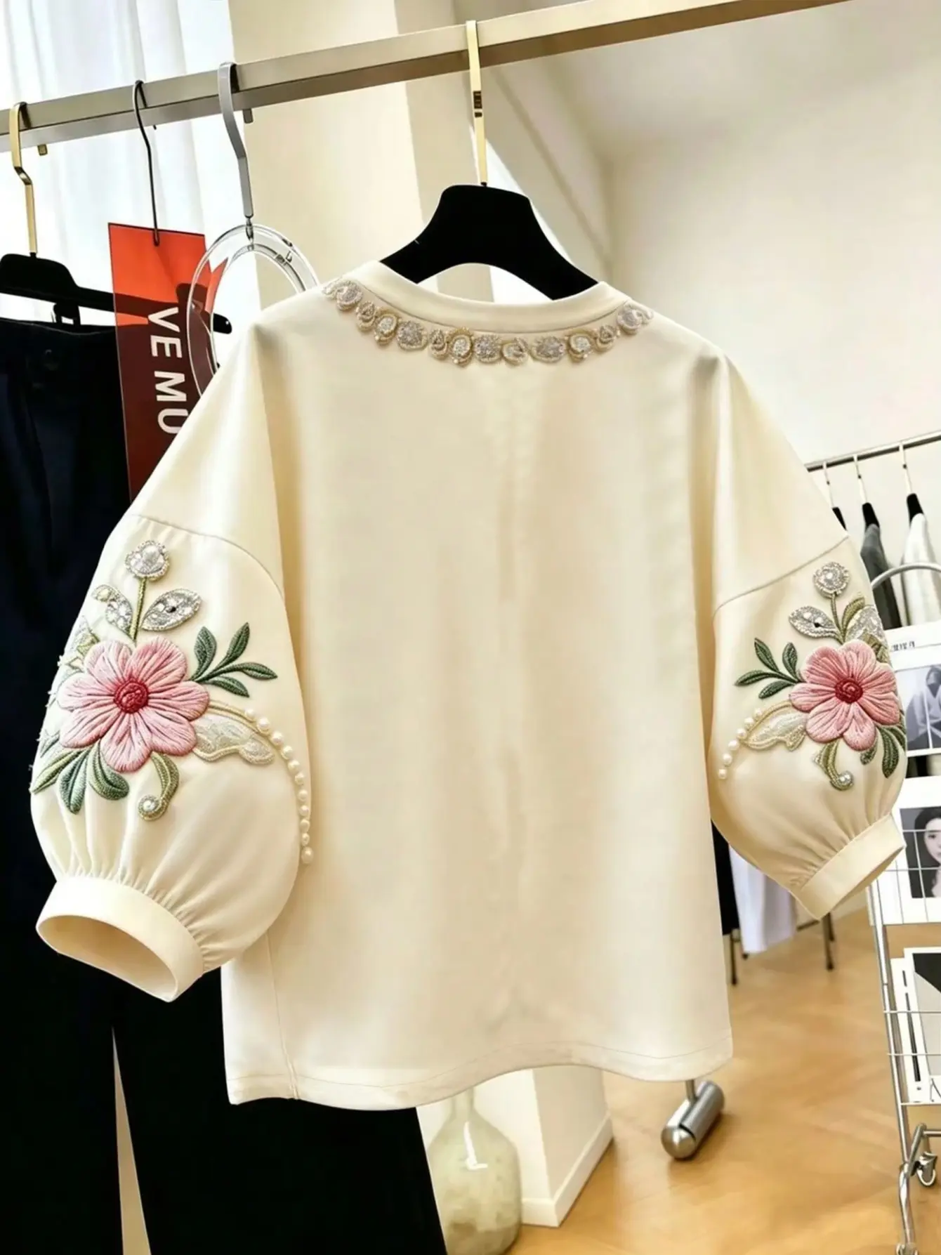 Back view of cream petal-sleeve top