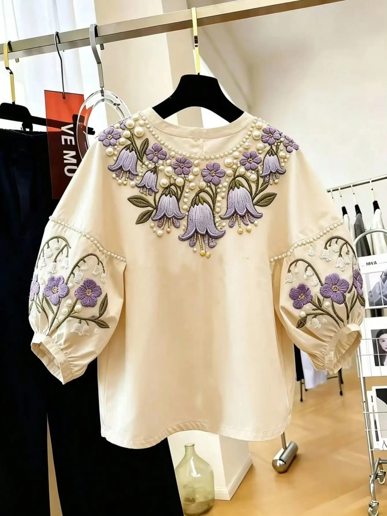 Cream petal-sleeve top with purple floral embroidery