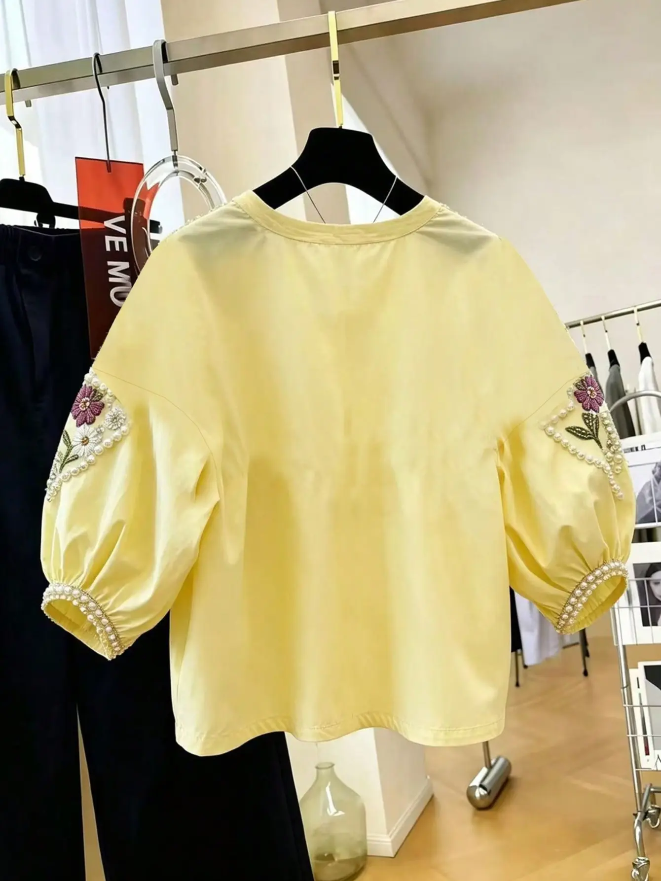 Back view of yellow petal-sleeve top