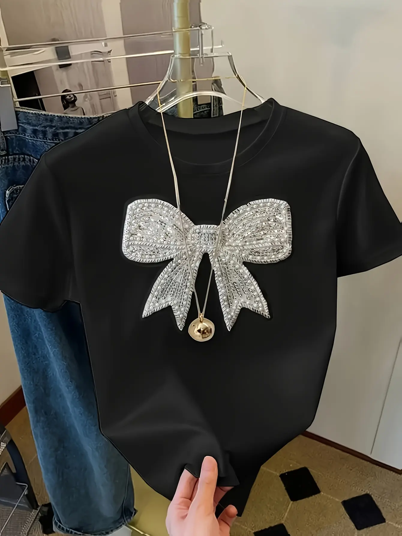 Black crew-neck T-shirt with silver bow applique