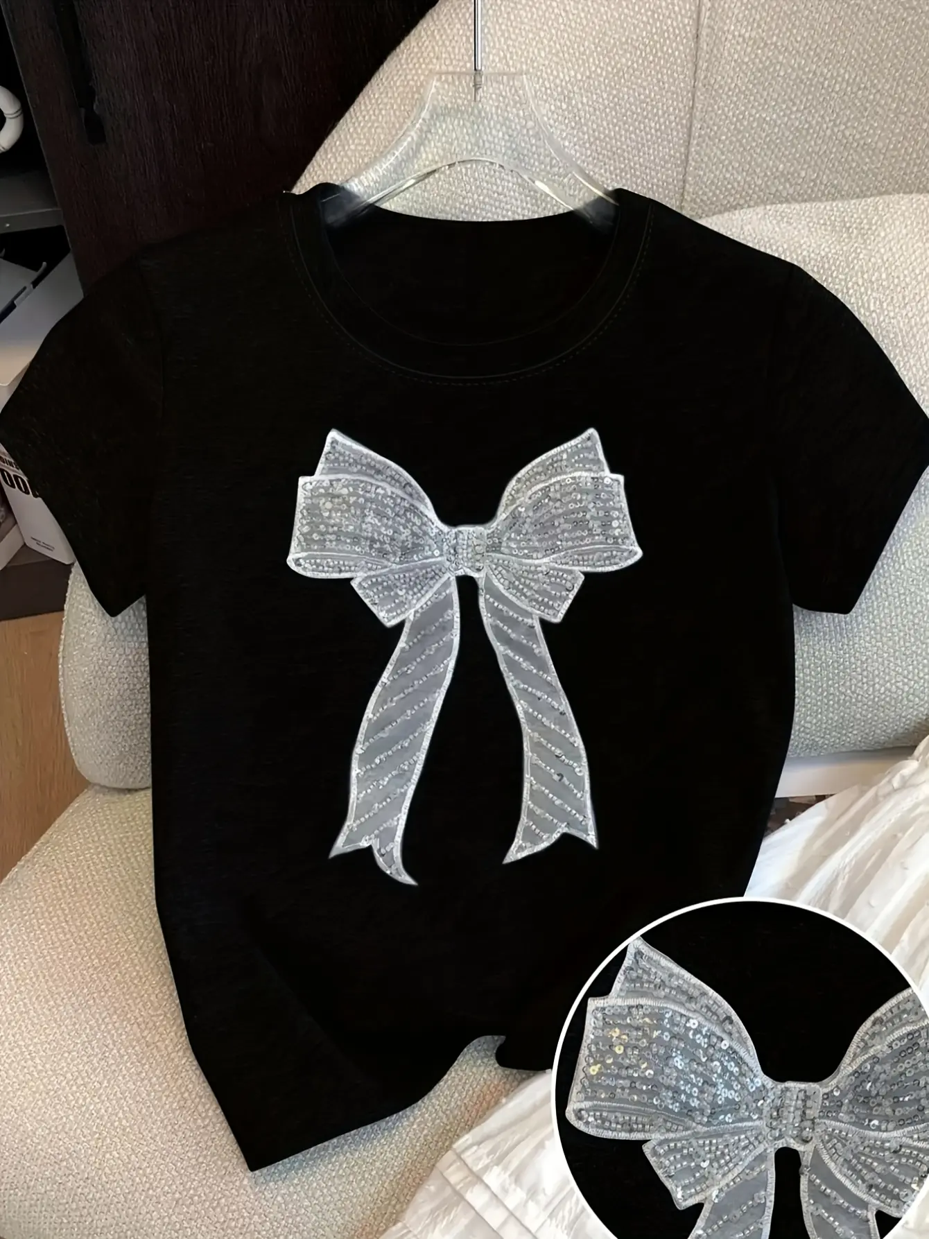 Black short-sleeve T-shirt with silver sequin bow