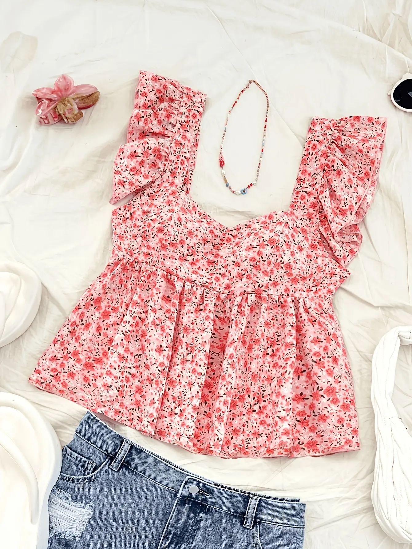 Women’s pink ditsy floral ruffle-trim peplum top styled flat lay