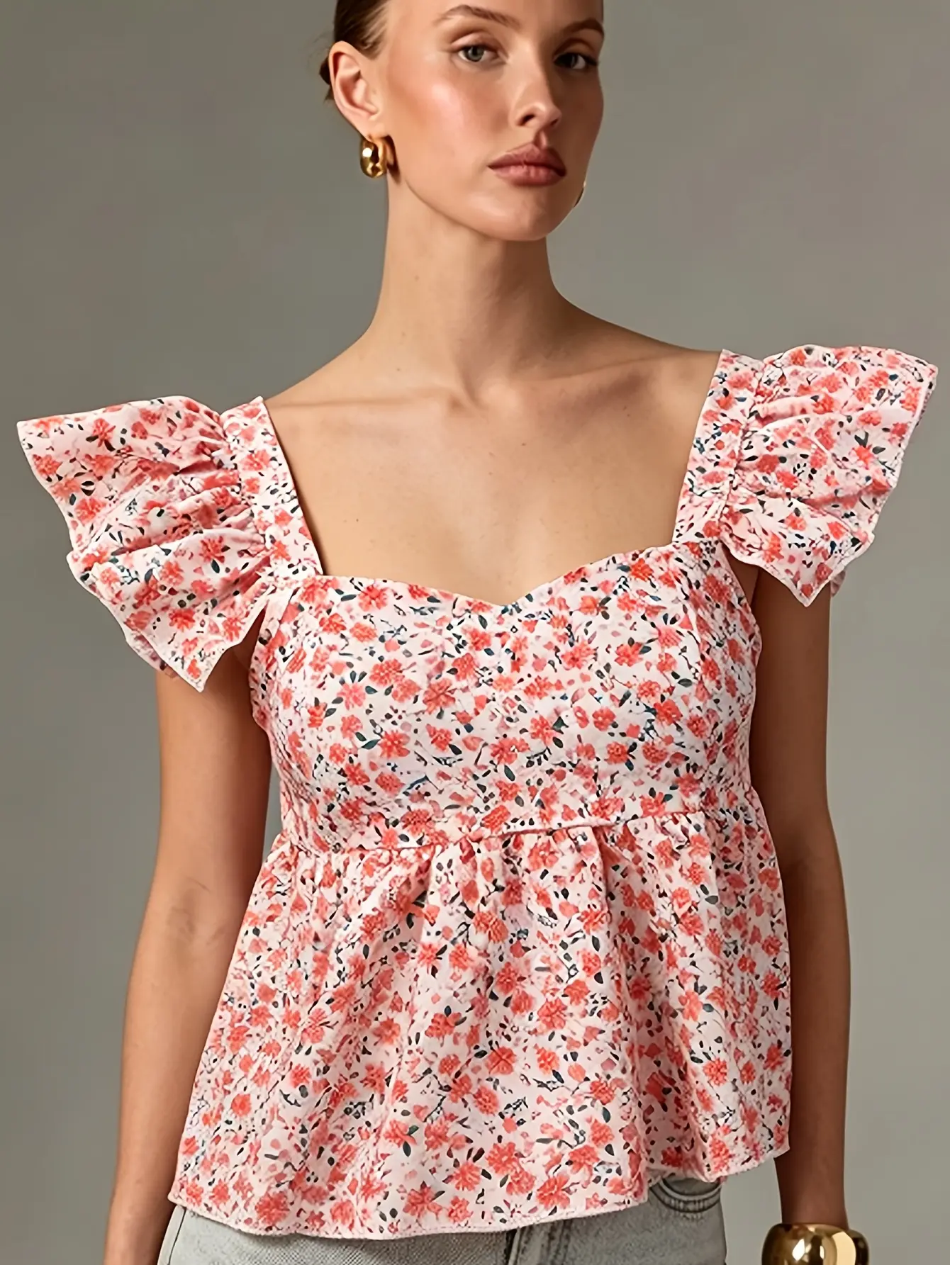 Women’s pink ditsy floral ruffle-trim peplum top on model