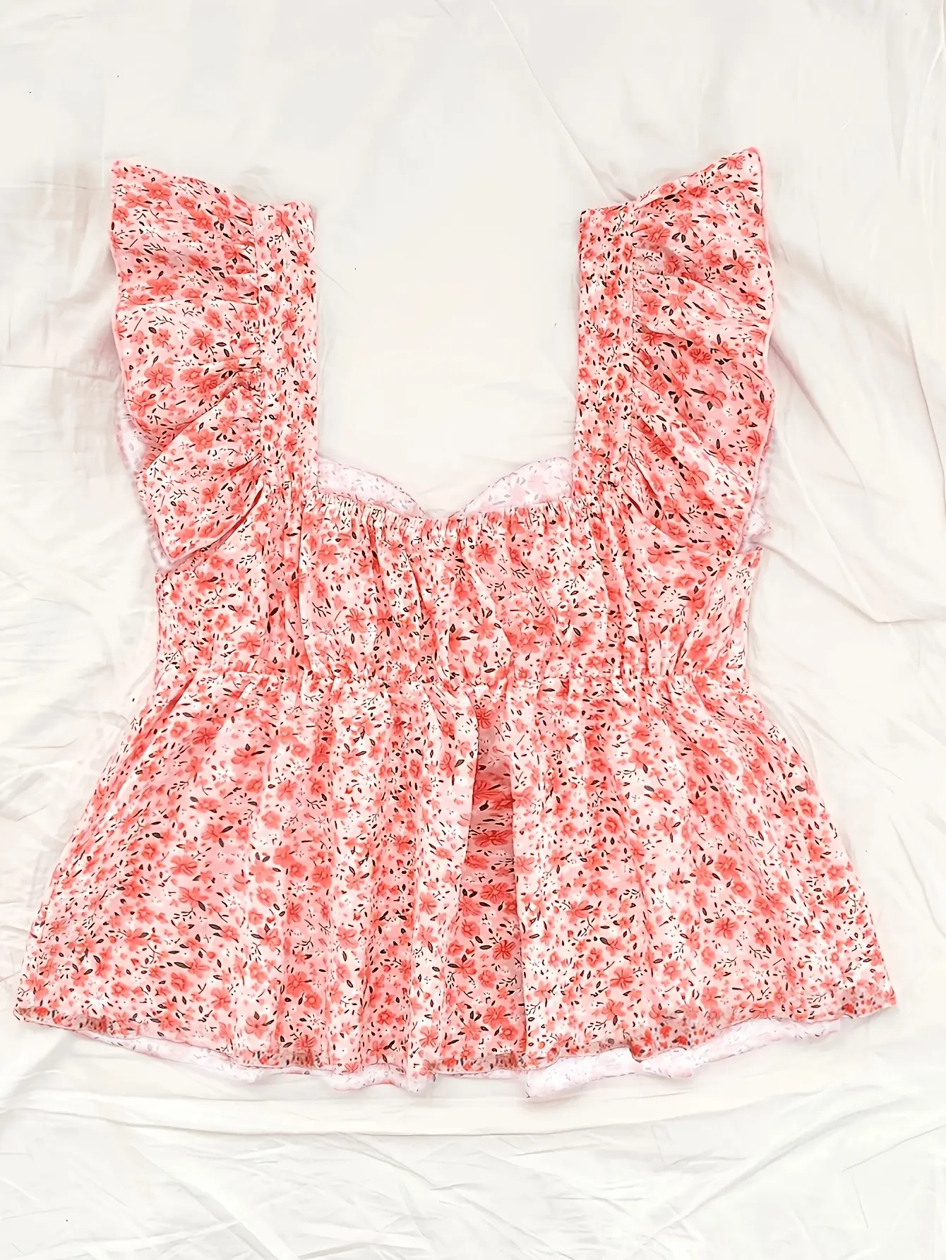 Women’s pink ditsy floral ruffle-trim peplum top flat lay