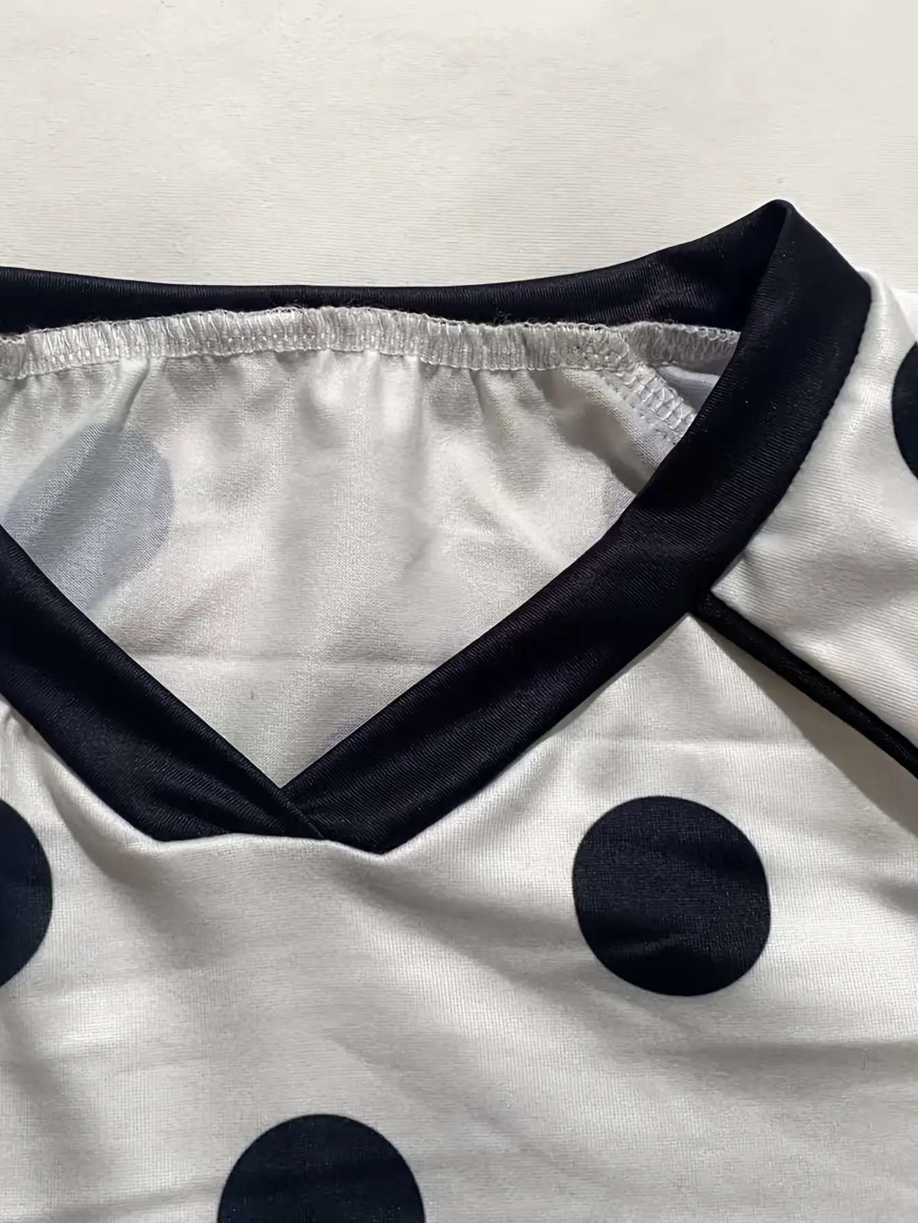 Women’s white polka-dot T-shirt neckline detail
