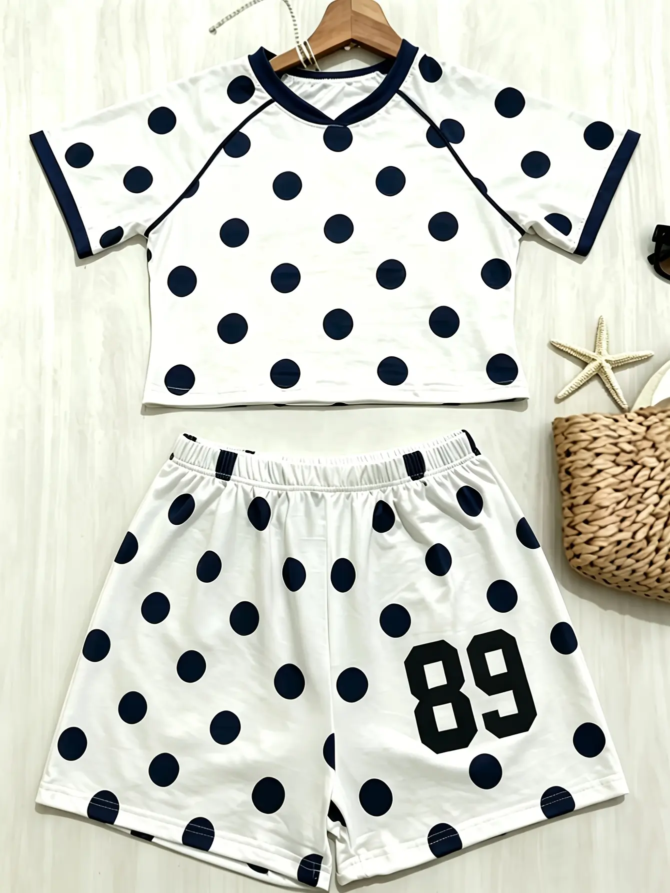 Women’s white polka-dot T-shirt and shorts set styled flat lay