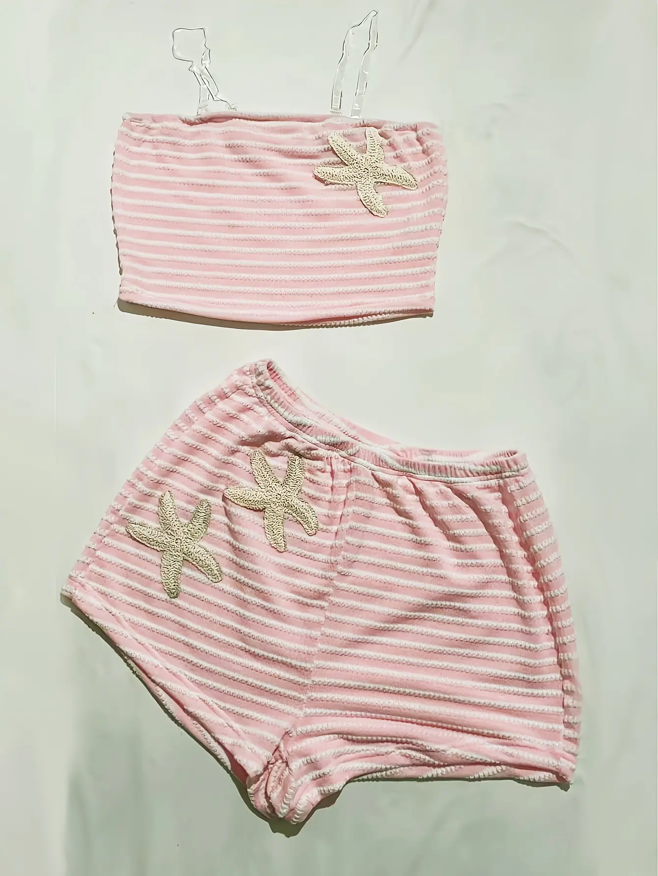 Women’s pink starfish cami and striped shorts set flat lay