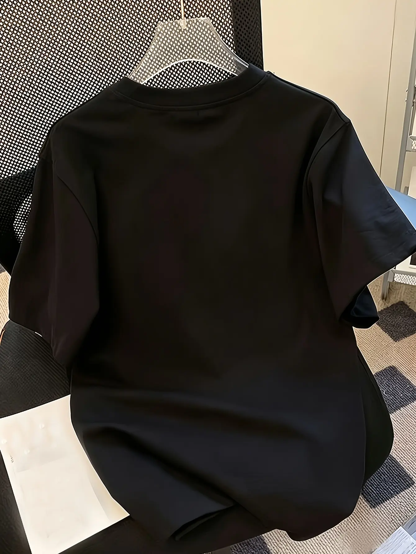Back view of black crew-neck short-sleeve top